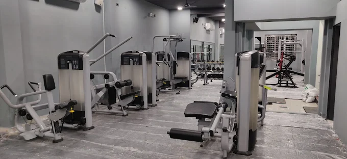 Strength training zone with smith machine, dumbbells and weight plates
