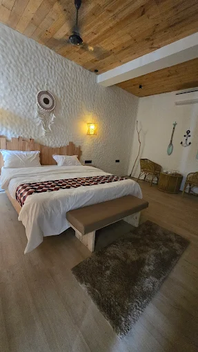 Sunlit suite with wood ceiling and rattan chairs
