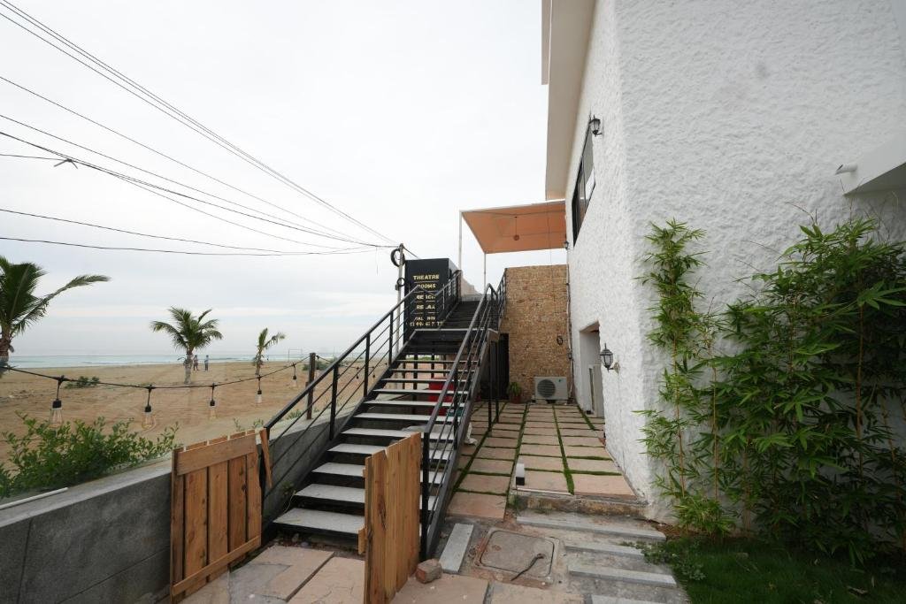 Exterior staircase leading up to the Theatre Rooms, beach visible behind