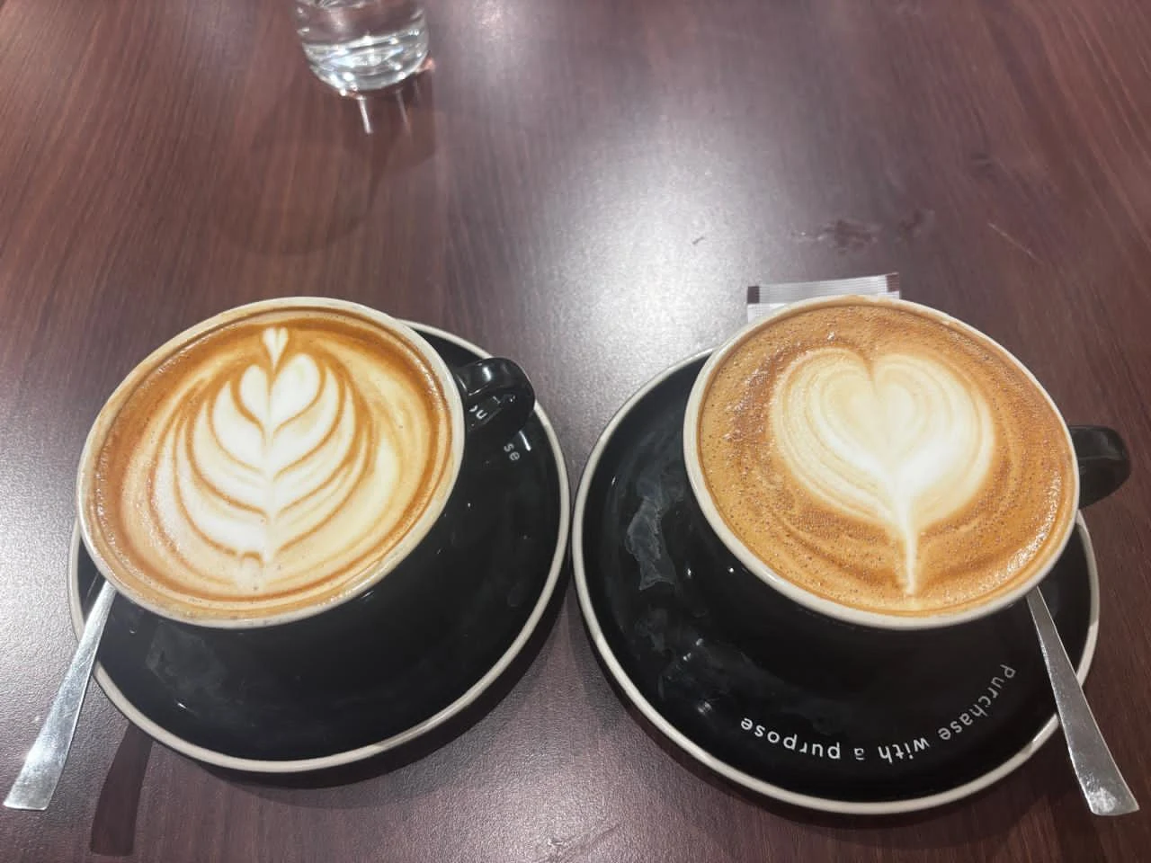 Latte art in a black cup at Writer's Café
